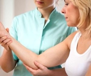 A Physical Therapist Treats a Tennis Elbow patient